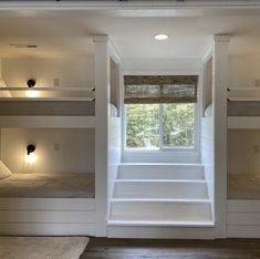 the bunk beds are all white and have built - in shelves with lights on them