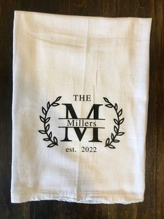 a white towel with the m millers logo on it sitting on top of a wooden table