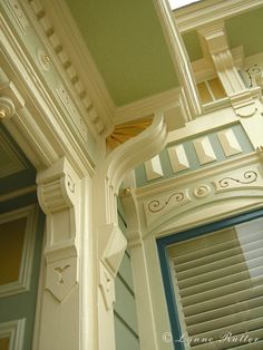 the corner of an ornate building with shutters