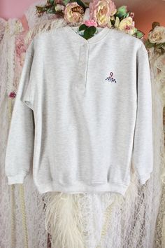 "*Vintage 80s 90s Gray Cozy Sweatshirt* Pre Loved Great Condition No Stains, Rips or Holes Vintage Possibly 80s 90s Brand: Unknown Gray Sweatshirt Unisex Small Floral Embroidery on the Left Front 3 Top Button Closure Long Sleeves Cozy & Comfortable for Autumn/Winter Season Material: 100% Cotton..Soft Fleece inside Size Approx. Small/Medium Check the Measurements Below Measured Laying Flat Shoulder to Shoulder: 20 1/2\" Across Sleeves: 19 1/2\" Armpit to Armpit: 20 1/2\" Waist: 40\" Around Length Vintage Embroidered Cotton Sweater, 90s Embroidered Sweatshirt For Fall, 90s Embroidered Fall Sweatshirt, 90s Embroidered Winter Tops, Vintage Crew Neck Sweater With Buttons, Vintage Embroidered Sweatshirt, Small Floral Embroidery, Sweat Gris, 80s Sweatshirt