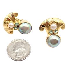 About This Piece: These rare vintage Paula Crevoshay earrings are one-of-a-kind (OOAK) pieces crafted in 18k gold. Featuring abalone, pearls, and blue gemstones, they showcase Crevoshay's exceptional artistry and meticulous craftsmanship. Elegant and distinctive, these earrings add a unique touch of luxury to any fine jewelry collection. Metal: 18k Yellow Gold Measurements: 25.5mm x 30mm Weight: 22.8 grams Stones: 2x Abalone Pearls: 13.5mm 2x White Pearls: 6mm 4x Blue Gemstones (Aquamarines?): 3 Luxury Formal Pearl Earrings With Mother Of Pearl, Luxury Mother Of Pearl Earrings For Formal Occasions, Unique Gold Cabochon Earrings, Gold Pearl Earrings With Gemstones For Formal Events, Gold Pearl Earrings With Gemstone For Formal Occasions, Formal Gold Pearl Earrings With Gemstone, Formal Mother Of Pearl Round Earrings, Formal Pearl Earrings In Mother Of Pearl, Formal Mother Of Pearl Earrings For Pierced Ears