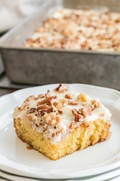 a piece of cake sitting on top of a white plate next to a baking pan