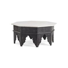 a black and white coffee table with an intricate design on the top, sitting against a white background