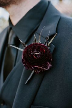 a man in a suit with a flower on his lapel