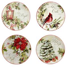 four plates with christmas designs on them and one has a red bird sitting on the tree