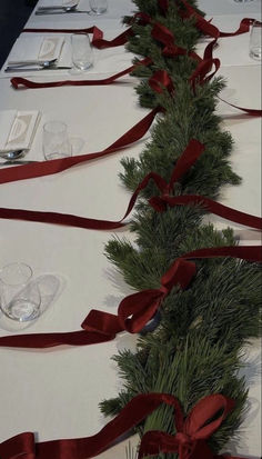 the table is decorated with red ribbon and silverware