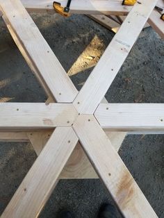 a person standing in front of a wooden structure that is being built into the ground