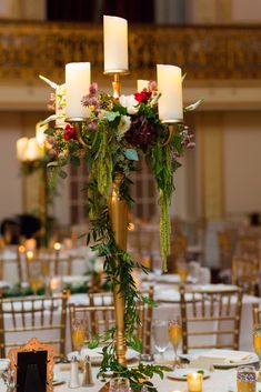 the centerpiece is adorned with greenery and candles