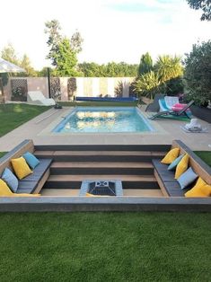 a backyard with a swimming pool and lounge chairs