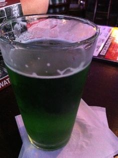 a green drink sitting on top of a table