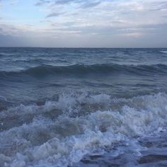 the ocean waves are crashing on the beach