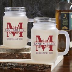 two personalized mason jars sitting next to each other