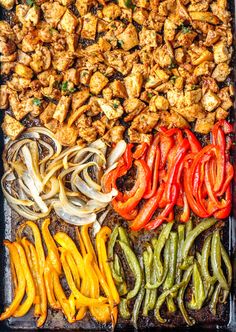 an assortment of vegetables and meats on a sheet pan, ready to be cooked