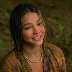 a close up of a person with dreadlocks and a smile on her face