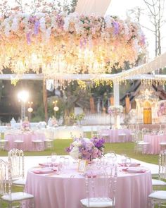 an outdoor wedding reception with pink and white decor