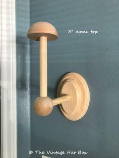 a close up of a wooden object on a wall near a door with blue paint