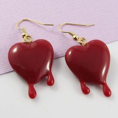 Cute'n'Kitsch Earrings with 3D Bleeding Heart Charms      Great Halloween Accessory!       Materials:     Earring Hooks - Brass   Charms - Resin      Approx. Total Earring Length:  45mm Pierced Heart Drop Earrings For Valentine's Day, Handmade Heart-shaped Novelty Earrings, Novelty Heart-shaped Earrings For Gift, Red Heart-shaped Novelty Jewelry, Novelty Earrings For Valentine's Day Party, Novelty Earrings For Party On Valentine's Day, Valentine's Day Heart-shaped Novelty Earrings, Handmade Novelty Earrings For Valentine's Day, Valentine's Day Novelty Dangle Earrings