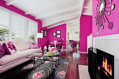 a living room filled with furniture and a fire place next to a wall mounted tv