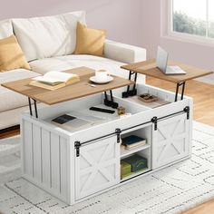 a living room with a couch, coffee table and laptop on top of the table