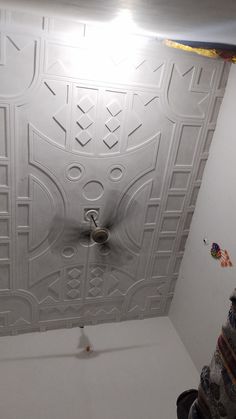 the ceiling is white and has decorative designs on it, as well as a fan