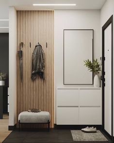 an entryway with a bench, coat rack and plants on the wall next to it