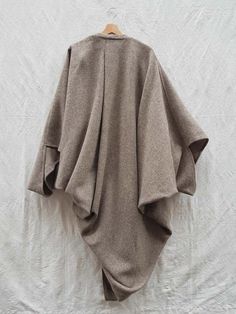 For Sale on 1stDibs - Heavy wool cocoon coat by Issey Miyake, an archive piece! -Heather beige/grey -Pleat detail on back -Oversize fitting -Made in France -100% Wool -1976 Oversized Beige Wool Sweater Coat, Oversized Beige Lagenlook Outerwear, Beige Lagenlook Outerwear For Fall, Oversized Beige Cape Outerwear, Beige Wool Cape Outerwear, Oversized Long Sleeve Beige Cape, Beige Wool Cape For Fall, Fall Lagenlook Cape Outerwear, Cocoon Jackets