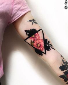 a woman's arm with flowers on it and a triangle in the middle,