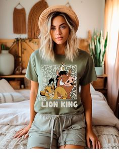 Step into the pride lands of nostalgia with our "Hakuna Matata Nostalgia Tee" – a roaring tribute to the timeless charm of The Lion King! Crafted from soft, high-quality cotton, this tee is not just a piece of clothing; it's a journey back to the golden era of animated classics. Feel the rhythm of the jungle as you showcase iconic characters like Simba, Timon, and Pumbaa in vibrant retro hues. The design captures the essence of the beloved film, making it a must-have for fans of all ages. Whether you're reliving childhood memories or embracing the magic for the first time, our tee is the perfect companion. The shirt features a comfortable fit and durability that ensures it stands the test of time, just like the enduring spirit of The Lion King. It's not just an article of clothing; it's a Feel The Rhythm, Film Making, The Pride, The Lion King, Iconic Characters, The Lion, Lion King, Piece Of Clothing, The Golden