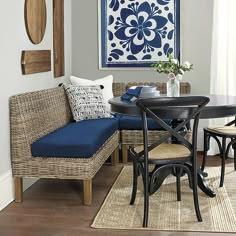 a dining room table and chairs with blue cushions