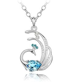 a blue crystal swan necklace with diamonds on the bottom and side, sitting on a white surface