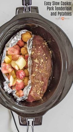 a slow cooker filled with potatoes and meat