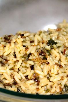 a bowl filled with rice and vegetables on top of a table