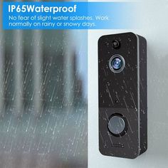 an image of a camera mounted to the side of a wall with rain falling on it