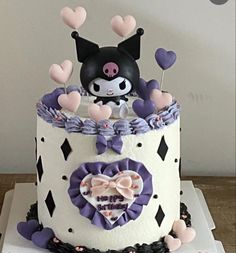 a cake decorated with an animal and hearts