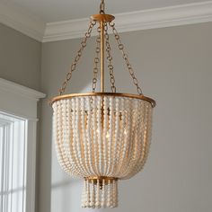 a chandelier with beads hanging from the ceiling