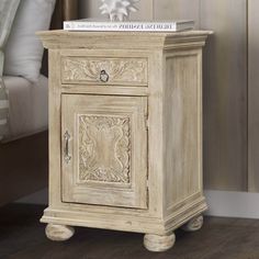 a white nightstand with a book on top