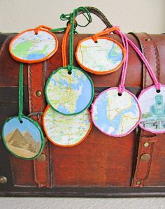 an old suitcase with luggage tags attached to it and some pictures hanging on the handle