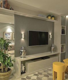 a large flat screen tv mounted to the side of a wall in a living room