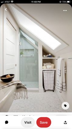 an attic bathroom with skylights and white walls, along with a large walk - in shower