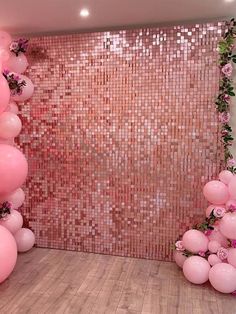 a room with pink balloons and flowers on the wall