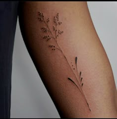 a close up of a person's arm with a tattoo on the left side