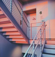 the stairs are painted pink and grey with numbers on each handrail to indicate where they are going