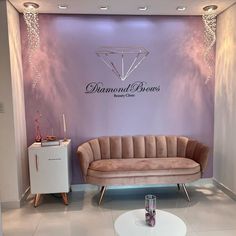 a living room with a couch and table in front of a wall that says diamond bros