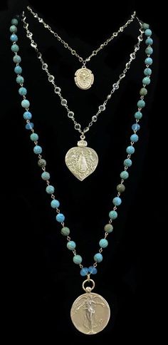 The Lujan Illumination Necklace features an intricately carved Our Lady of Lujan medal within a flaming Sacred Heart. She's surrounded by Angels, with two of them raising a crown of flowers above her. The Dove of Peace, an image of the Holy Spirit and Divine Life Force, hangs above her on gold linked channel set crystals. Shown paired with our Peace Angel in Turquoise, this listing is just for the double strand necklace in the first picture. To purchase the three together click here The gold dip Spiritual Carved Necklace For Wedding, Spiritual Carved Necklaces For Weddings, Spiritual Carved Medallion Jewelry, Surrounded By Angels, Crown Of Flowers, Dove Of Peace, The Dove, Special Necklace, Double Strand Necklace