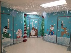 an office decorated for christmas with snowmen, reindeers and santa clause on the doors