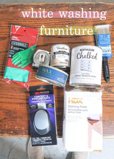 the contents of a whitewashing furniture sitting on top of a wooden table next to a pair of green gloves