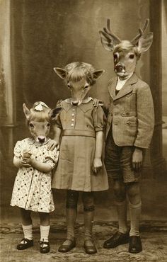 three children are standing next to each other with deer heads on their head and antlers on their ears