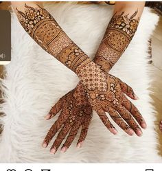 two hands with henna designs on them and the bottom half of each hand is shown