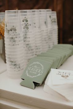 a table topped with lots of plastic cups and paper napkins next to each other