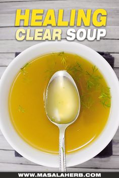 a white bowl filled with soup on top of a wooden table next to a spoon